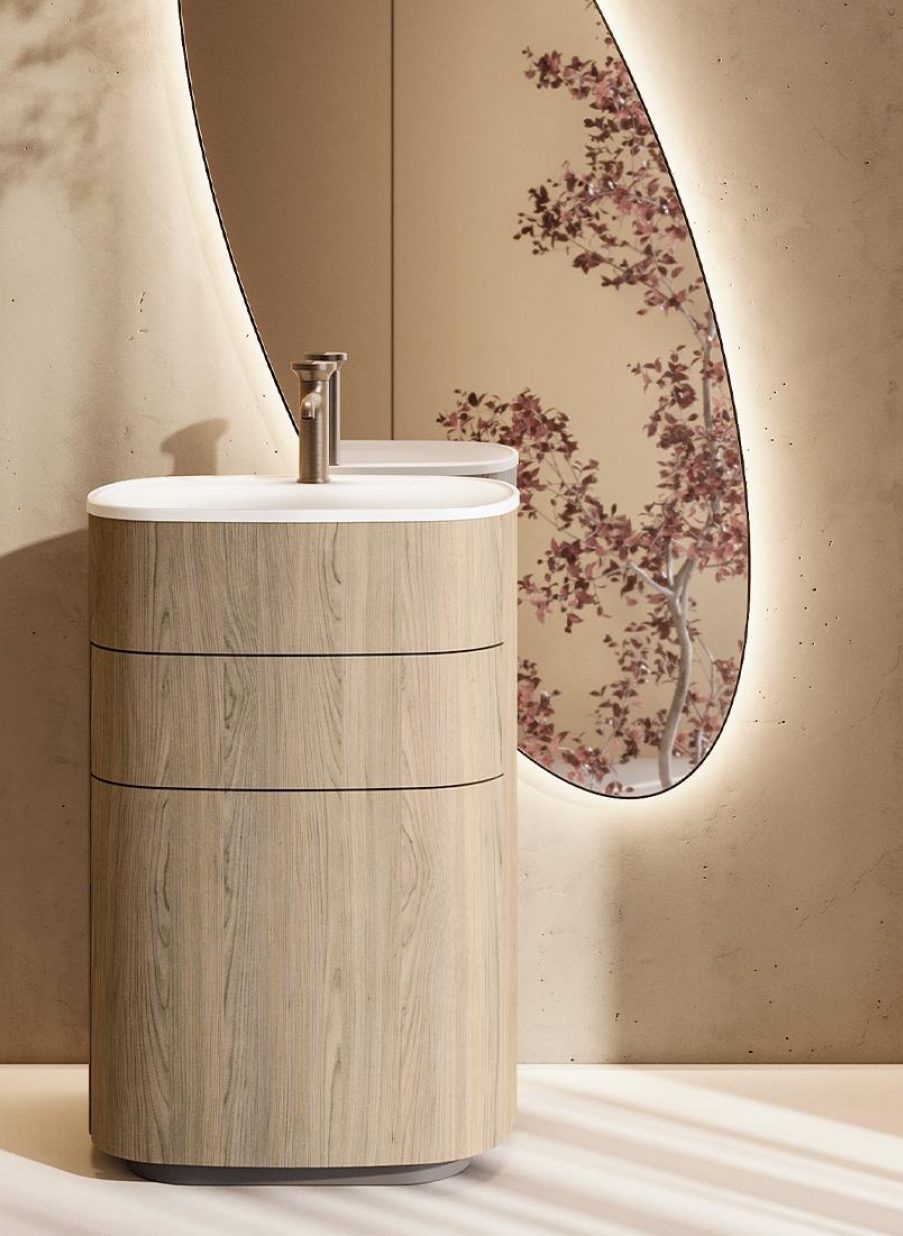 Mueble de baño italiano en madera clara con lavabo redondo sobre encimera